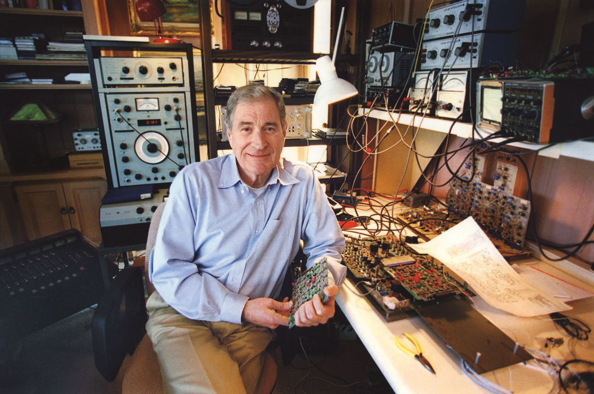 Ray Dolby in a studio surrounded by tech equipment