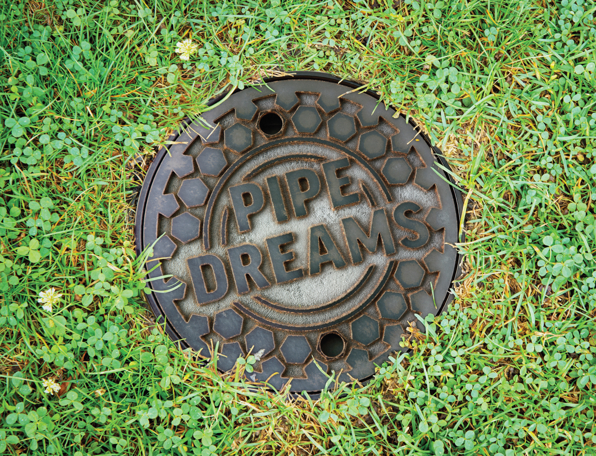 A manhole cover labeled: Pipe Dreams