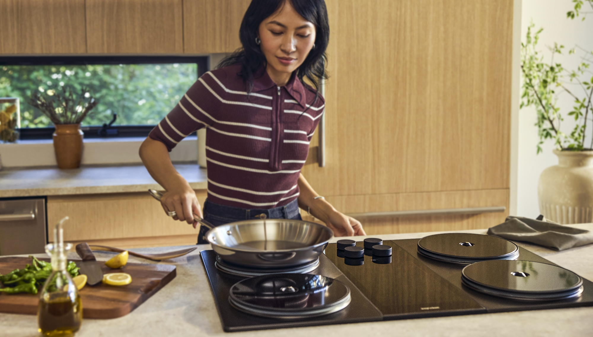 A woman using the Impulse Labs induction stove