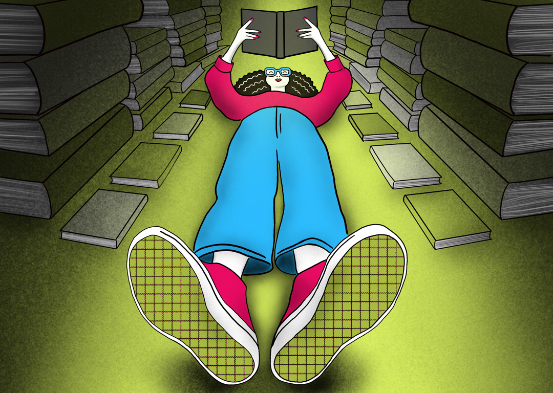 Woman laying on floor reading a book