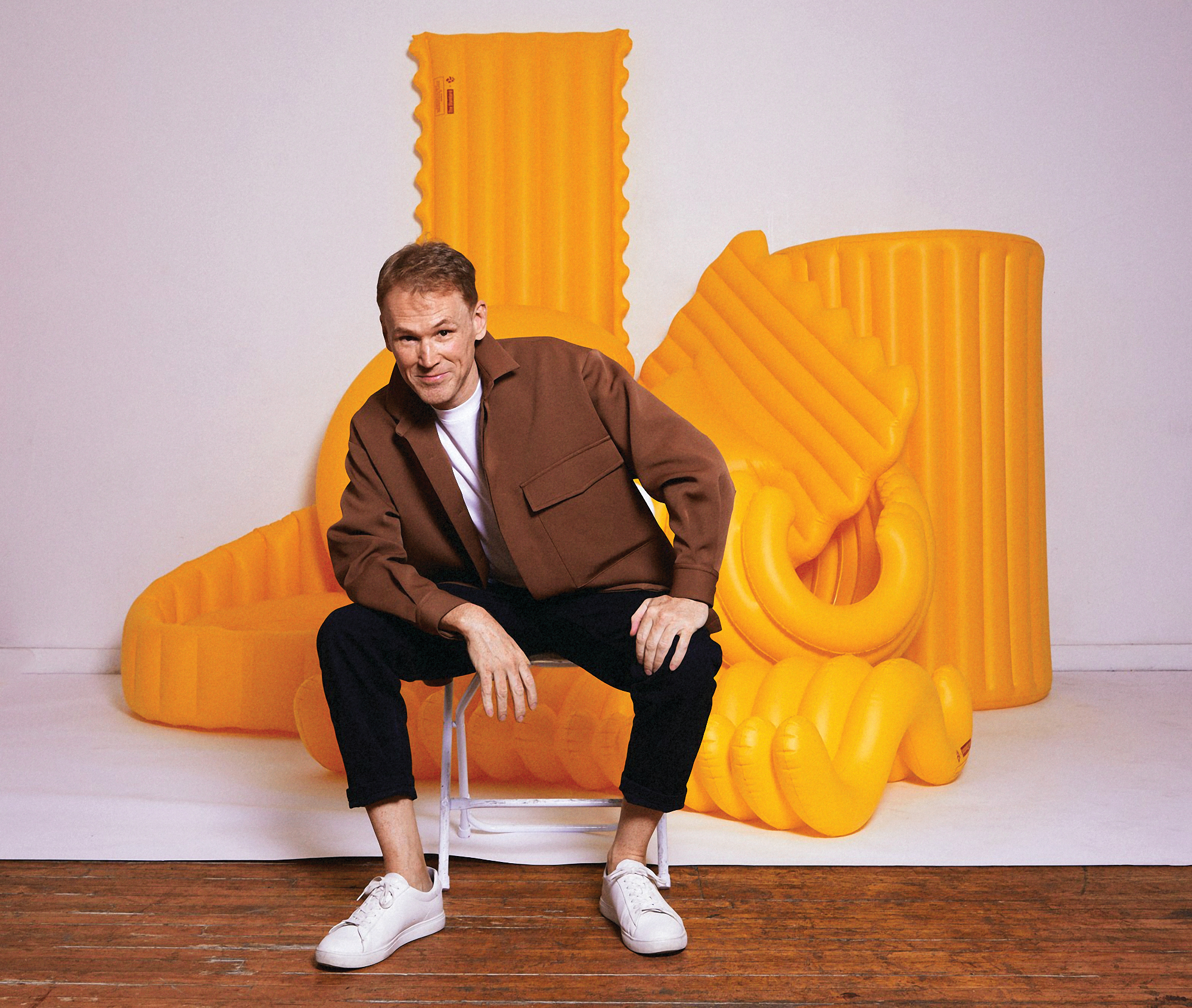 Donnelly sits with yellow pool floats shaped like pastas.