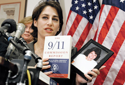 Carie Lemack holds a copy of the 9/11 Commission Report and a photo of her mother.