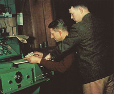 Hewlett and Packard are tinkering with some sort of complicated machinery.