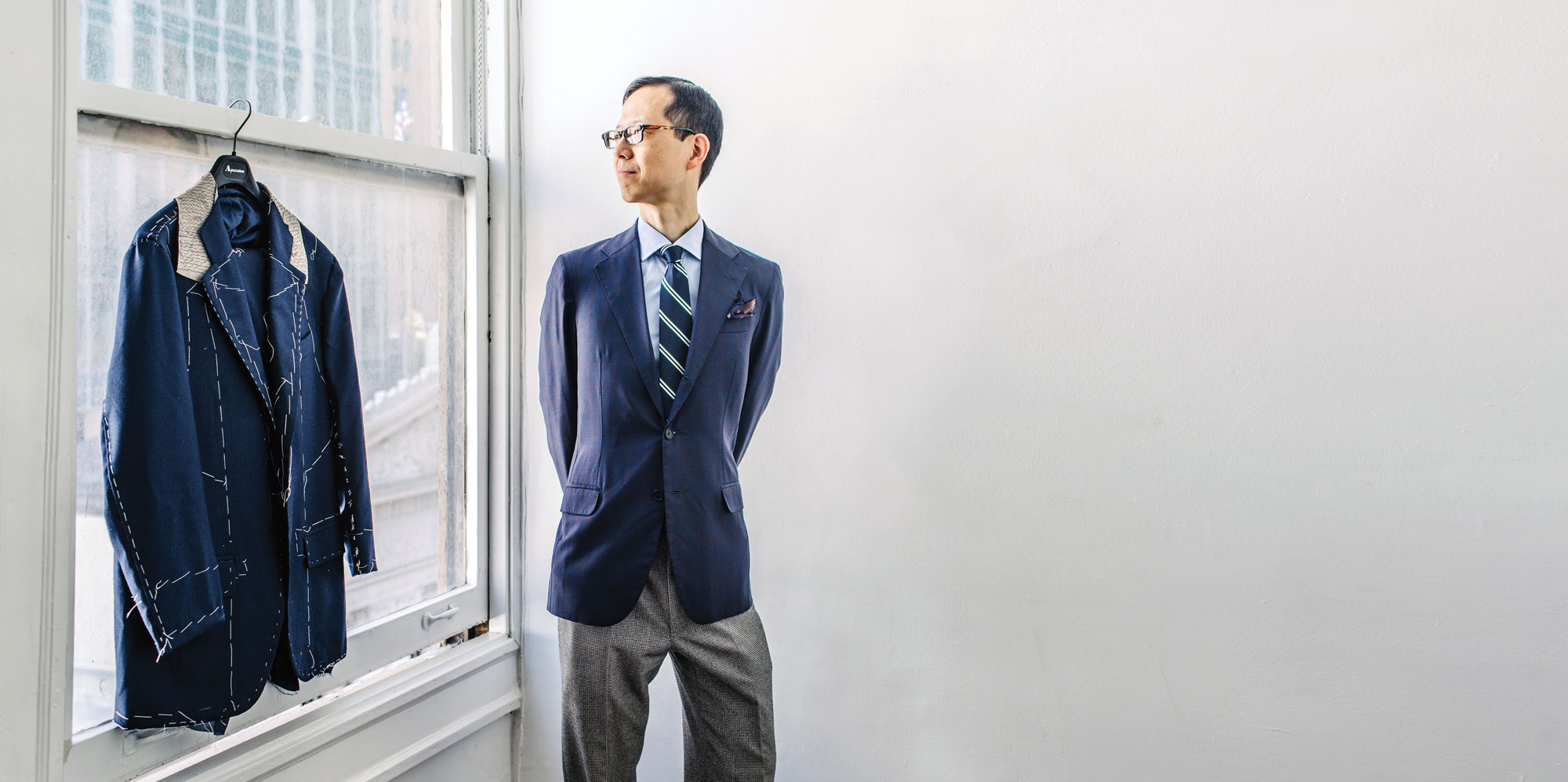 Photograph of Juhn Maing standing in studio