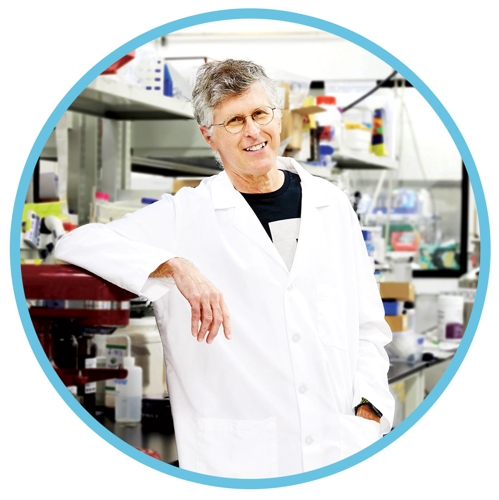 Pat Brown standing in the Impossible Burgers test kitchen wearing a lab coat. 