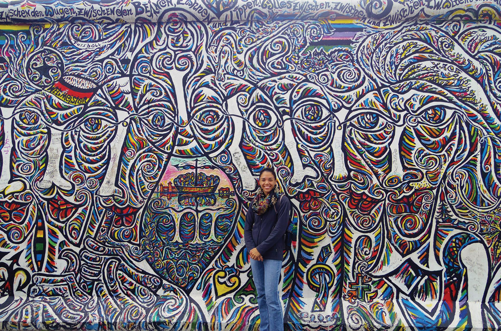Amber Moore in front of colorful wall in Berlin
