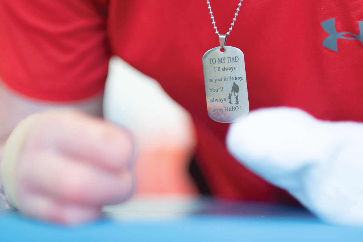 A necklace that reads, "To my dad, I'll always be your little boy. You'll always be my hero!"