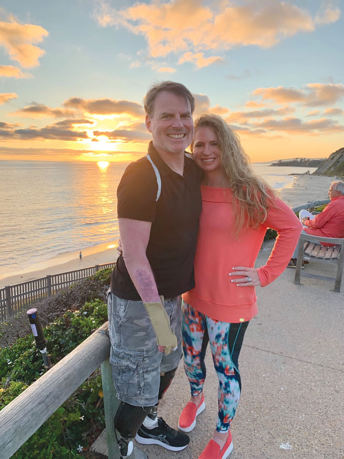 Marty Hartigan standing outside with his wife at sunset