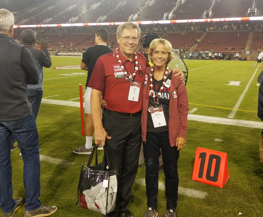 Joel and Karen Erickson on the field at a Stanford football game.