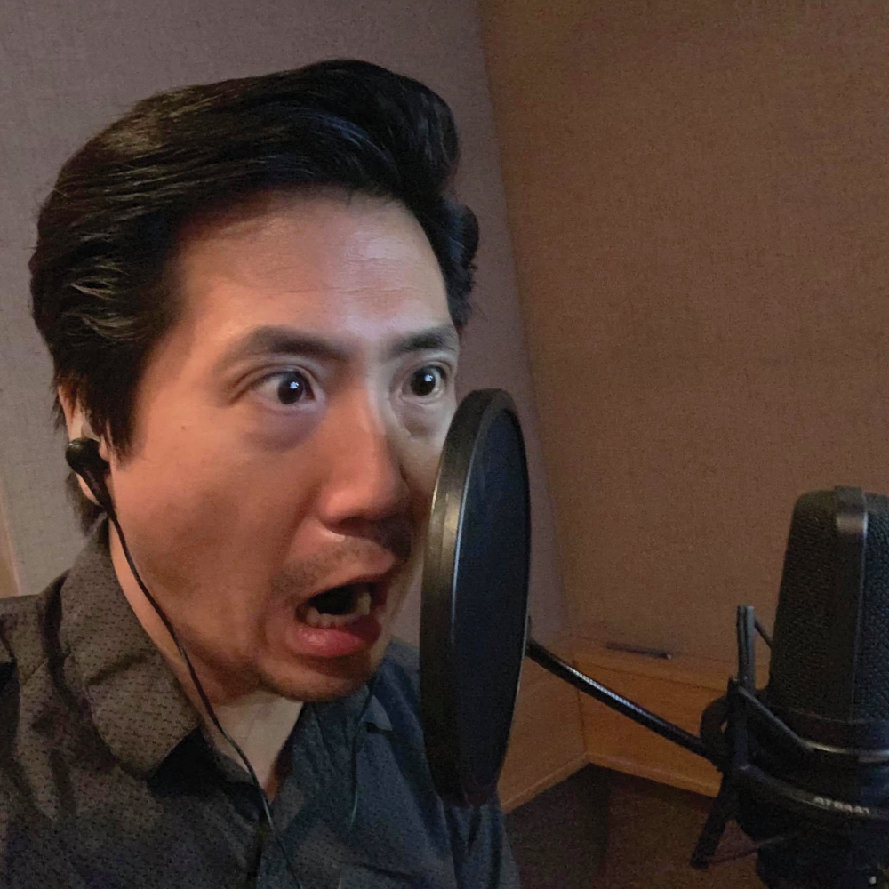 Greg Chun yelling into the mic.