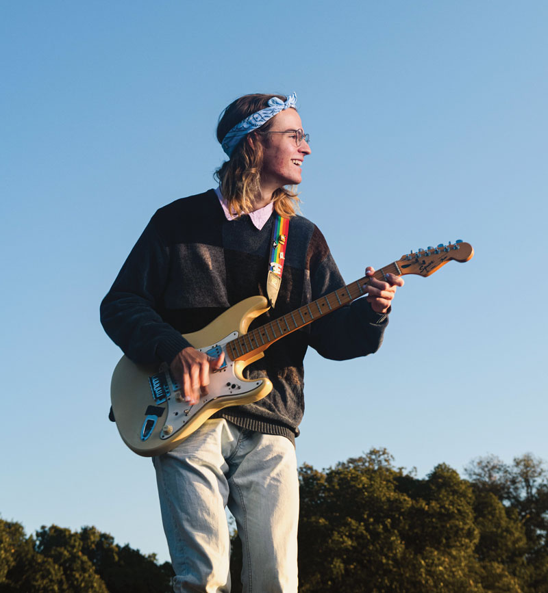 Brad Immel playing a guitar outside.