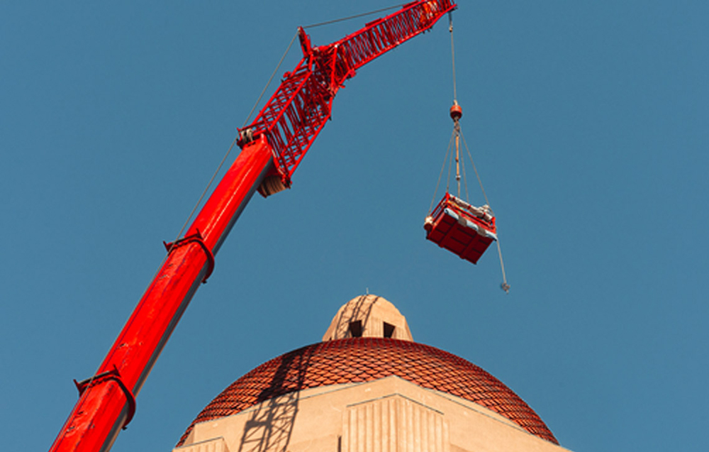 Crane replacing top of Hoover Tower