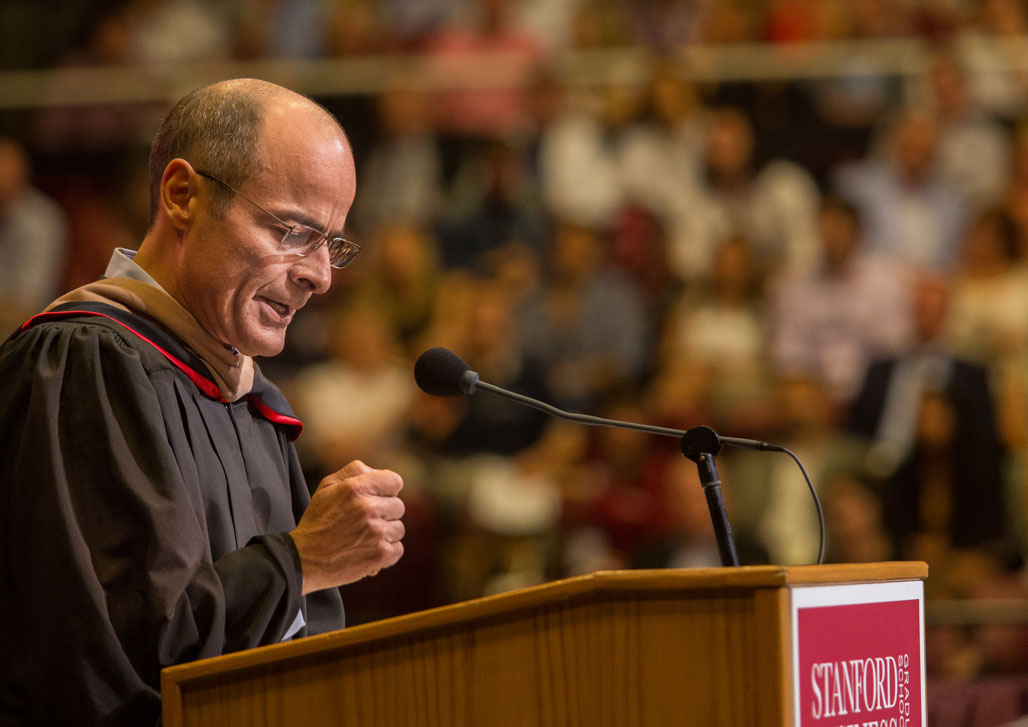 Photo of Carlos Brito speaking at a podium at Stanford Graduate School of Business