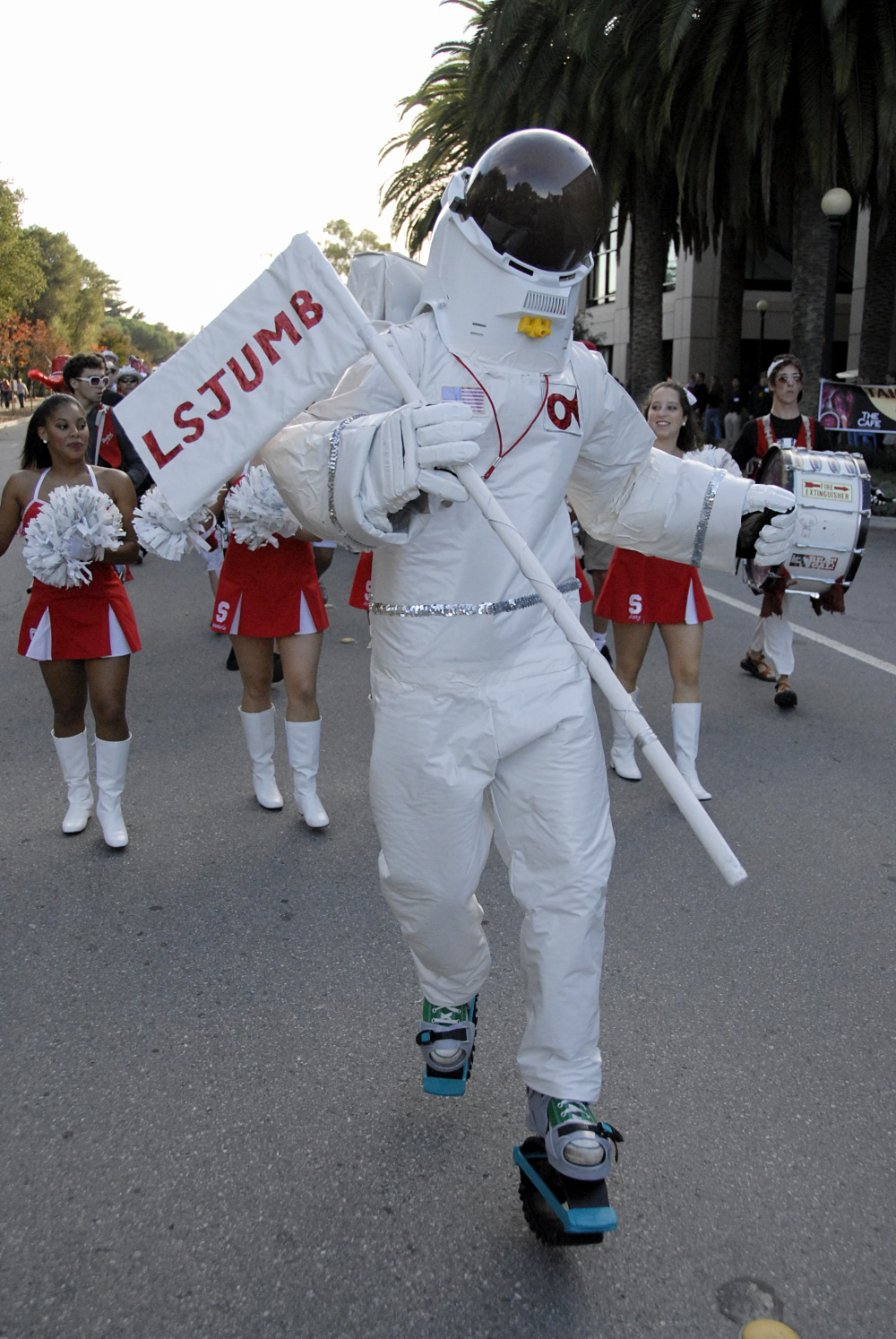 Band member in a space suit leading others