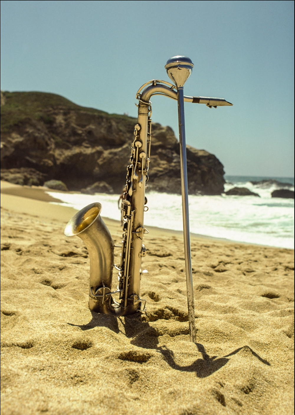 Saxaphone standing up in the sand