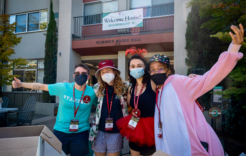 Happy students in masks outside Florence Moore Hall
