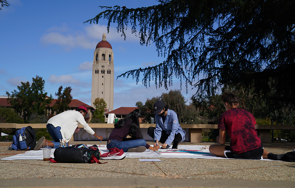 Students painting a mural on Democracy Day