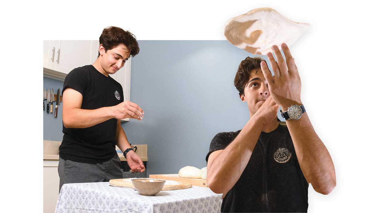 Diego Romero preparing and tossing pizza dough.