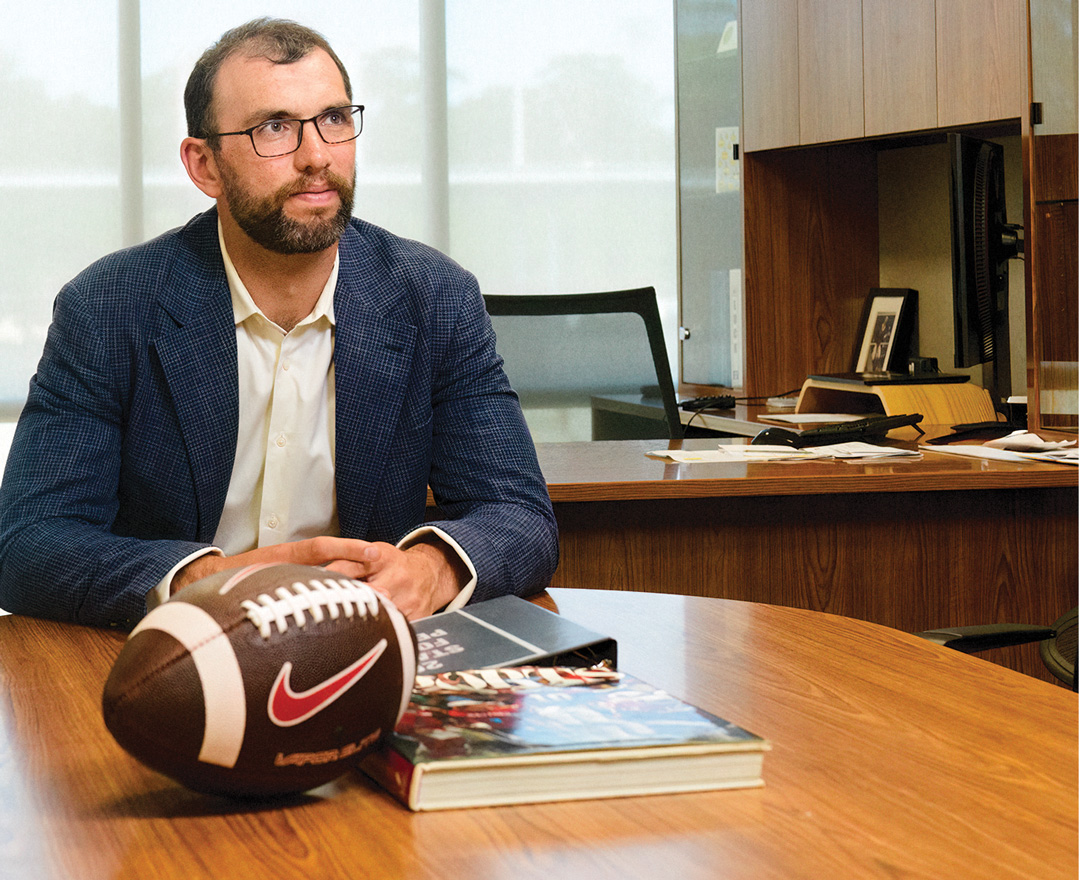 Luck seated at a table in his office