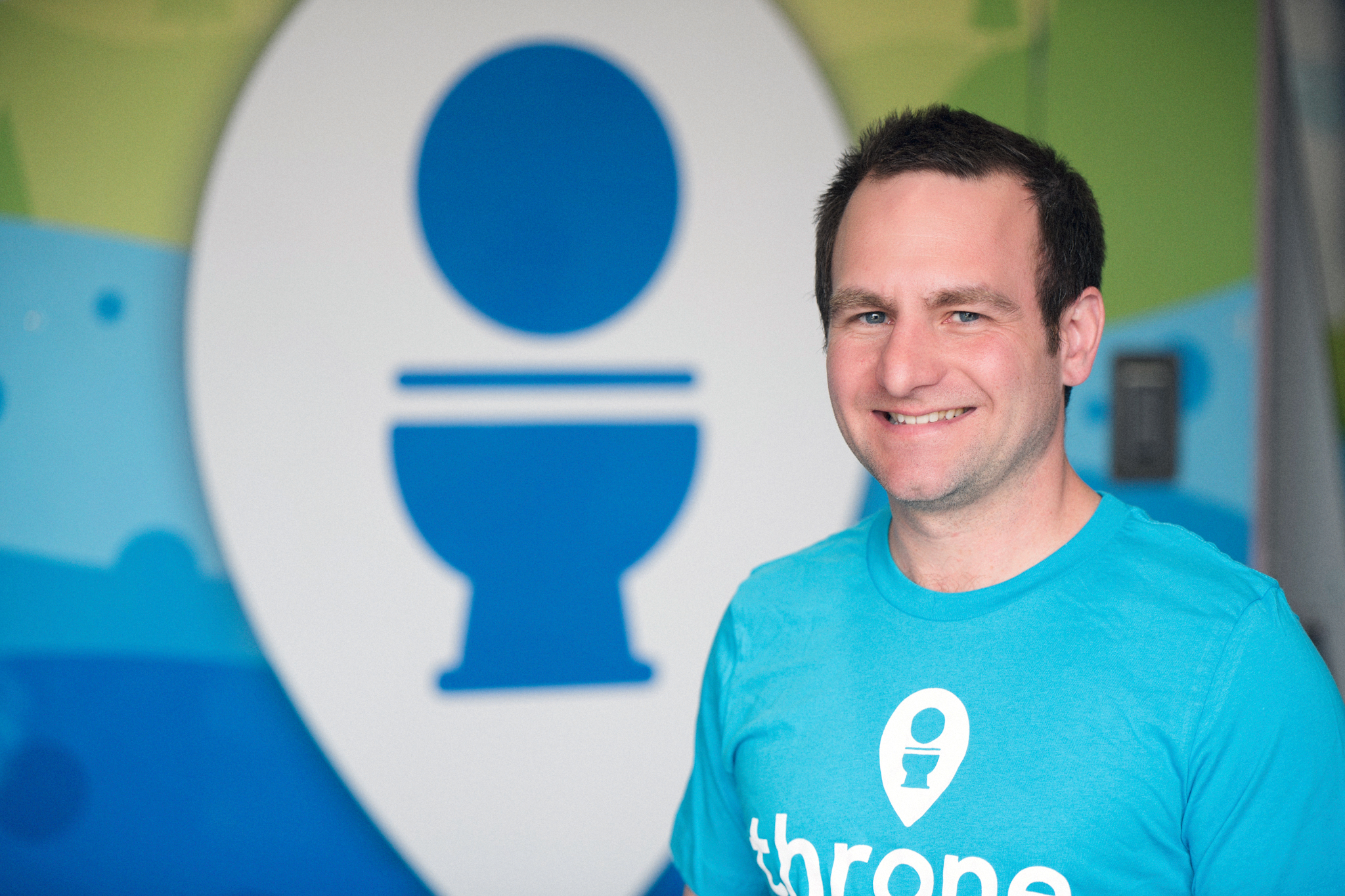 Fletcher Wilson standing next to a Throne 