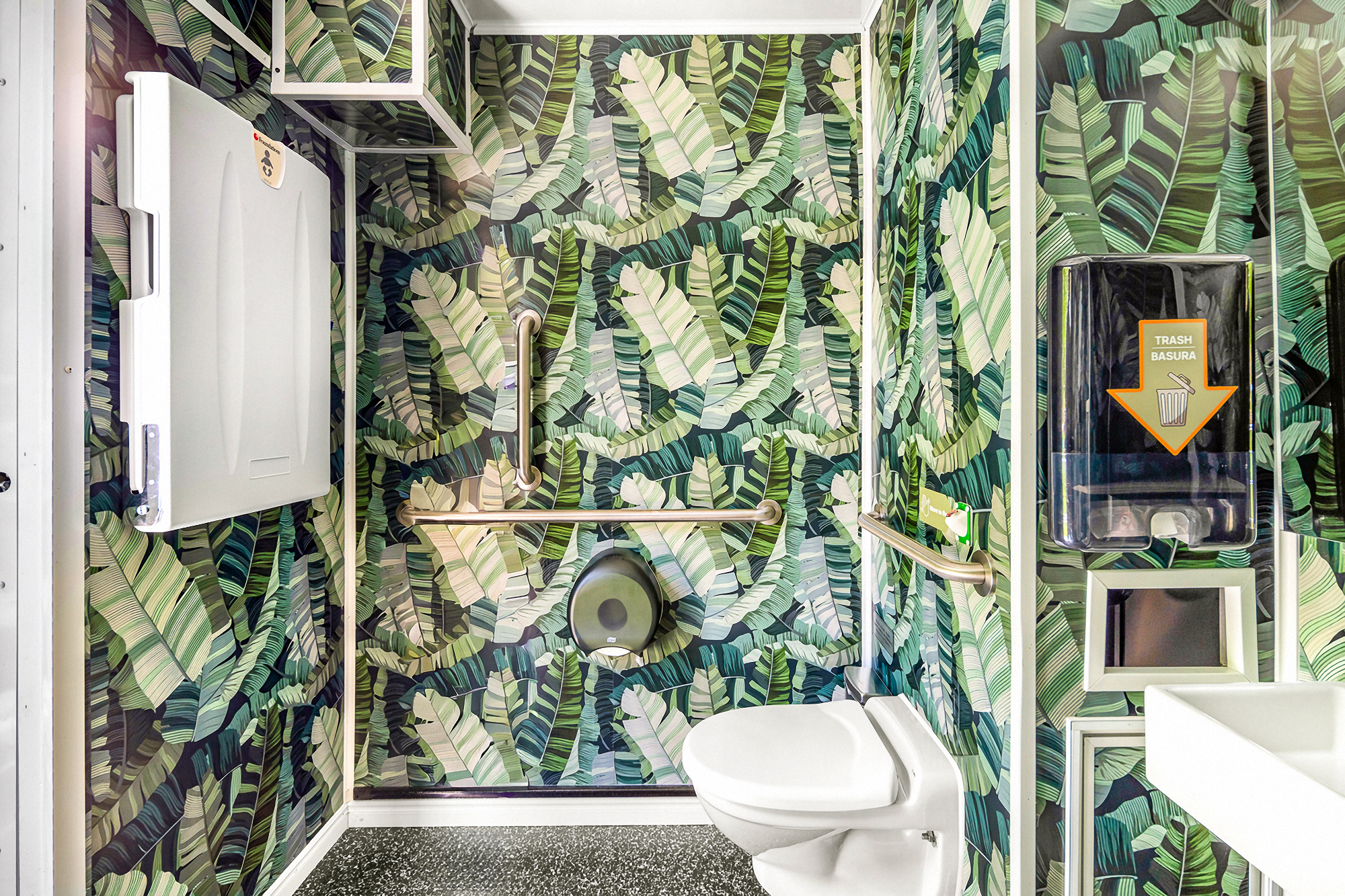 Interior of a Throne bathroom with toilet, sink and wallpaper