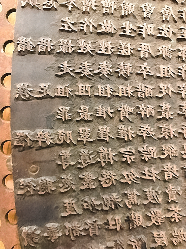 Close-up of Chinese characters on the metal disc