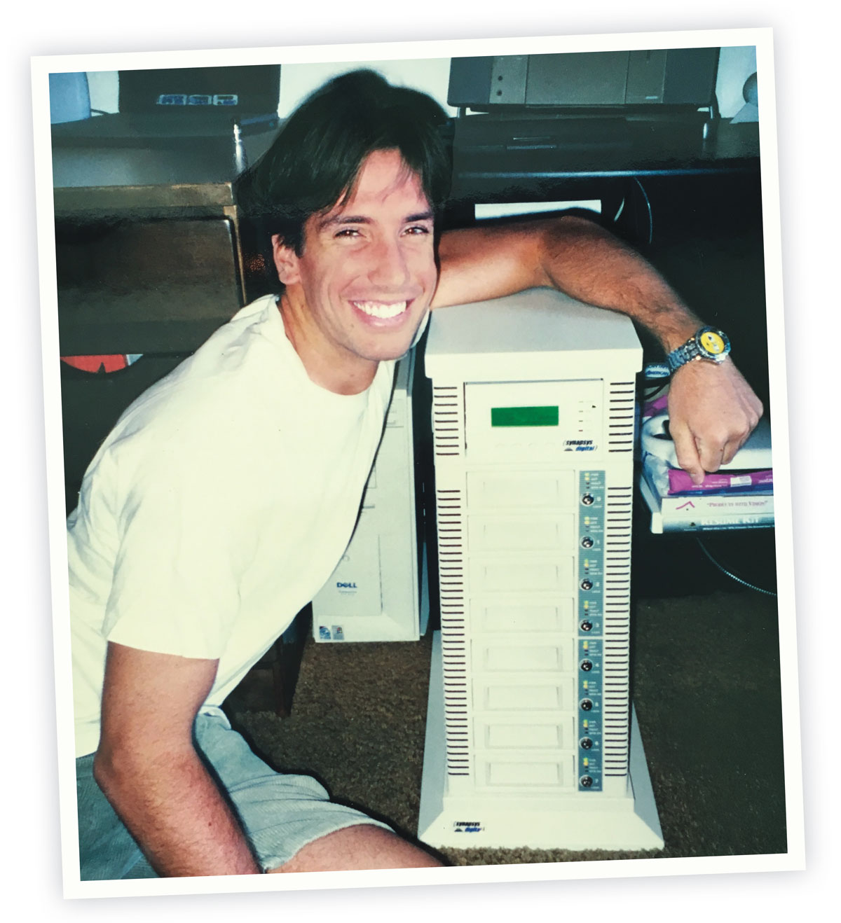 Isakovich at Stanford in the 1990s with his arm on a data storage array.