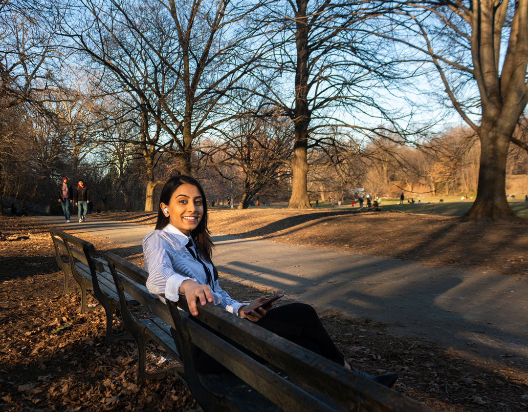 Naomi Shah sitting on a bench in Central Park