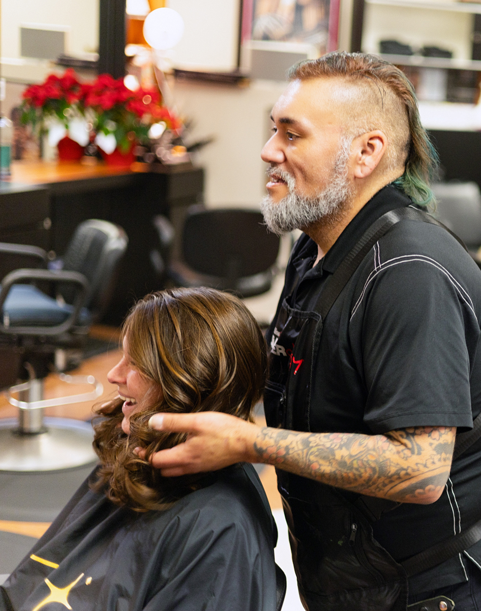 Author Jill Patton sitting in a chair while stylist Quintana-Mueting works on her hair.
