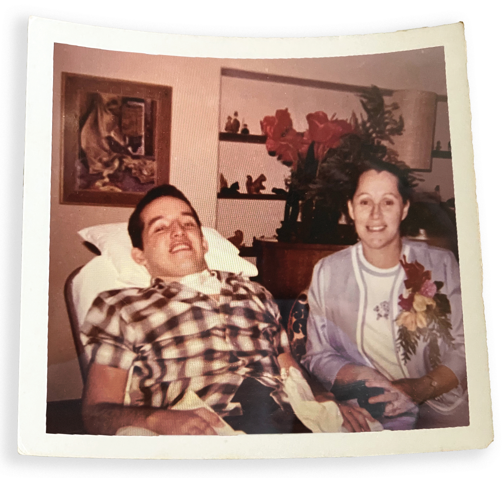 Lowell Wilson lying back with his mother sitting beside him