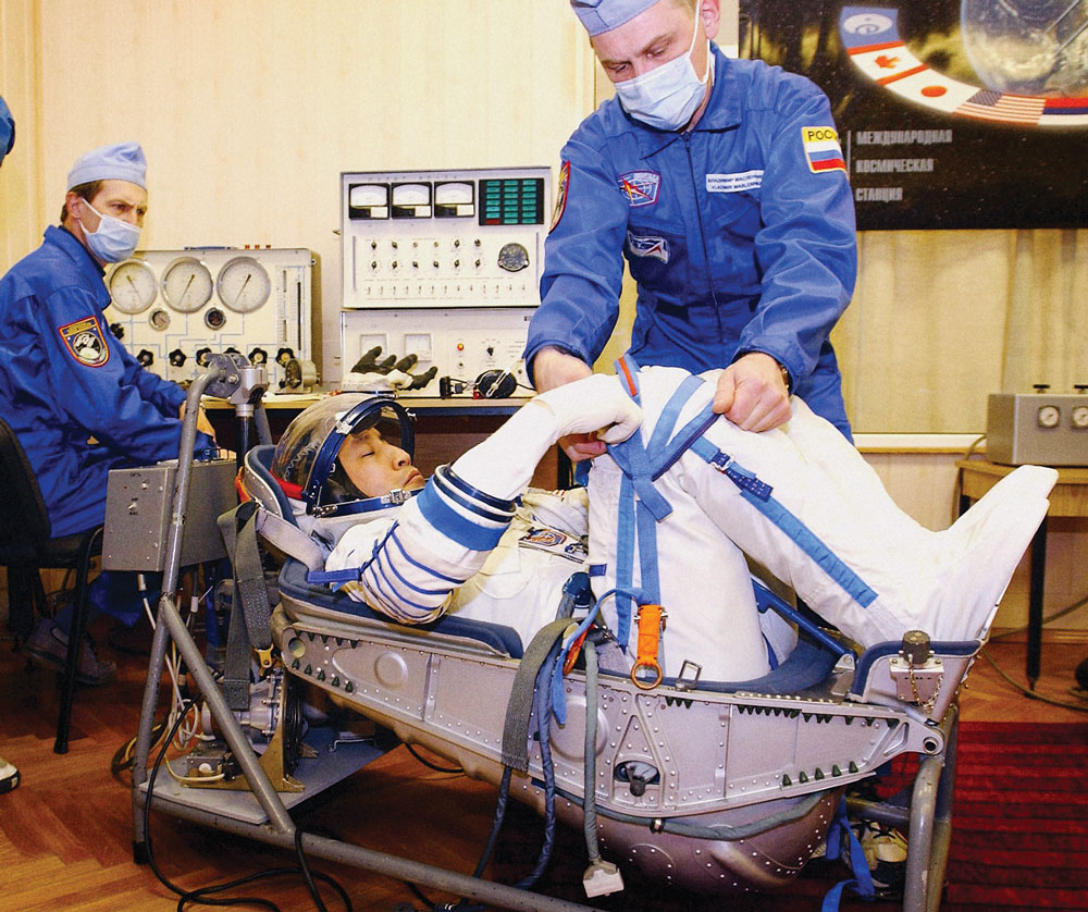 Ed Lu having his space suit checked