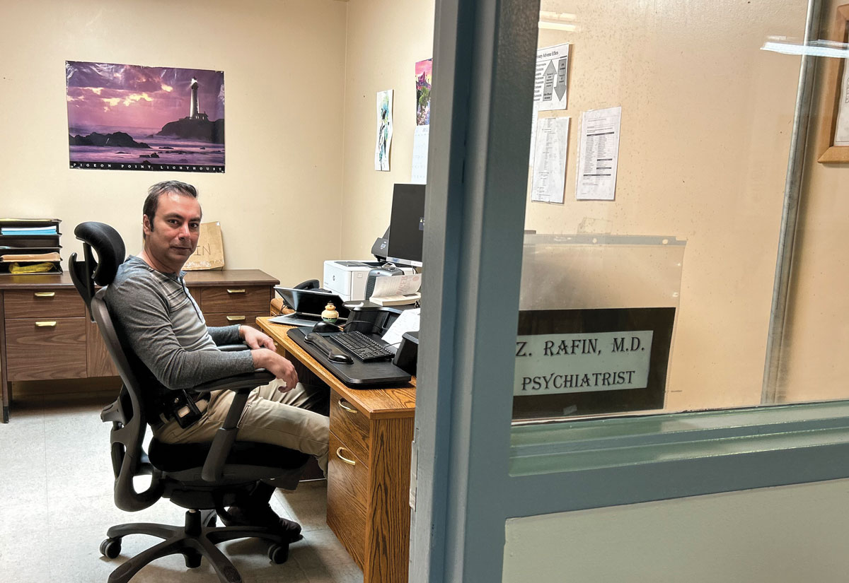 Rafin seated at his desk in his office.