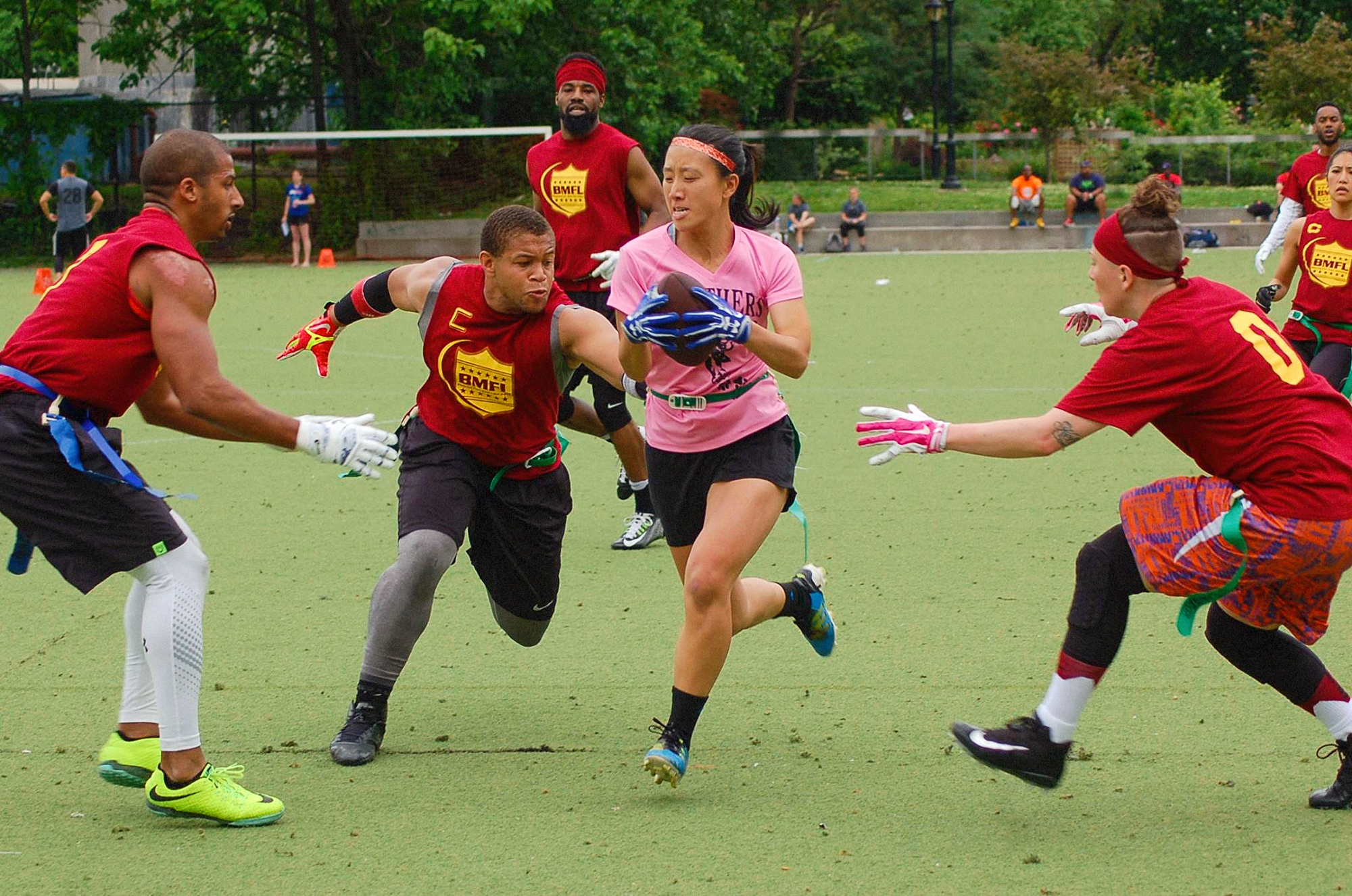 Stephanie Kwok running with the ball in a game of flag football