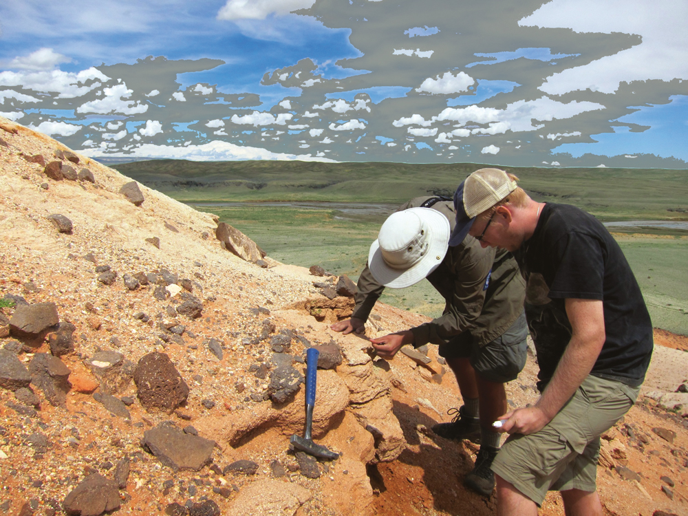 Two men examining a rock formation